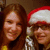 Two people in a close-up photo, one wearing a Santa hat, with visible pixelation and color shifts across frames.
