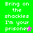Green background with white pixelated text repeating 'Bring on the shackles I'm your prisoner' and two star symbols, one pink and one gray.