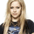 A person with long blonde hair wearing a black shirt with a blue graphic design, shown in a of four with one missing