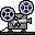 Two pixel-art film projectors on gray background, each with rotating reels and red indicator lights.