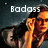 Pixelated image with 'Badass' text above two figures in warm-toned clothing against a dark background.