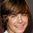 Pixelated portrait of a smiling person with brown hair, pink text reading "Mrs.", "Angelo", and "Effron" on black background.
