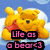 Pixelated yellow bear with red shirt against blue sky background, text overlay reads 'Life os o bear :)' in pink letters.
