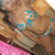 A woman in a blue bikini top lies on a wooden surface with a pink blanket, her head turned left to right across frames.