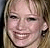 A four- with a pixelated photo of a smiling person on the top-left and three text in black pixelated font on white backgrounds