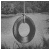Black-and-white animation of a circular swing with a central hole, suspended by a line, showing motion blur and text overlays.