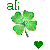 Pixelated green four-leaf clover with stem, small heart shape below right leaf, and partial text 'ali' above left leaf on white background.