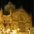 A pixelated golden structure with multiple domes and spires against a dark background, featuring bright white highlights on its lower section.