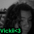 A grayscale pixelated image of a person with dark hair and closed eyes, overlaid with green text reading 'Vicki' at the bottom.