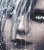 Pixelated close-up of a person's face with light skin, dark hair, and visible eye makeup including eyeliner.