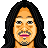 Pixelated static image of a male face with long black hair, mustache, goatee, and pink lips against white background.