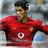 Pixelated image of a person wearing a red shirt with a white circular logo, dark hair, and a blurred background.