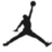 Black silhouette of a basketball player mid-jump with one arm extended upward holding a ball, legs spread wide apart, on a white background.
