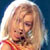 Static pixelated image of a person with light-colored hair wearing red clothing against a blue background.
