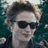 A four- shows a person with light brown hair and dark sunglasses against a blurred green background, overlaid with red text reading "Edward Cullen," "dazzling people since," and "1901." The top-right displays the full name while bottom-left reads "dazzling people since" and bottom-right shows "1901."