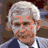 Pixelated image of a man with gray hair and glasses, showing multiple text overlays and facial expressions in a