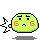 Pixelated green circular character with red 'G' marks on cheeks, black eyes and eyebrows, small mouth, gray shadow below; two versions show different left-side pixel patterns.