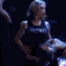 animated frames showing a woman in a black sleeveless top performing synchronized dance moves against a dark background with blue stage lights
