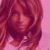 Pixelated static image of a person with long brown hair against a pink background, rendered in low-resolution digital style.