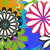 Pixelated static image of two flower-like shapes with radiating petals against a multicolored background.