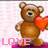 Brown teddy bear holding red heart, standing on pink base with partial text 'LAME' visible below.