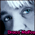 Pixelated image of a character with pale skin and blue eyes, labeled 'Draco Malfoy' in pink text, wearing a green and silver uniform with a tie.
