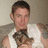 A person in a white sleeveless shirt holds a small dog while the word LOVE appears in bold red letters with black outlines on a white background.