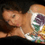 Pixelated image of a person lying down with a colorful floral design on their chest against a dark background.