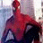 Animated Spider-Man figure in red and blue costume with white webbing, standing against a blurred background.