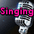 A silver microphone with black grille lines appears in four , each displaying different pink text: "Singing," "Is My," and "LIFE" across the top-left, top-right, and bottom-left sections