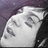 A static pixelated image shows a white, rounded object with dark gray patterns against a dark purple background.