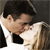 A pixelated image shows two people in a close embrace, one with dark hair and a white shirt, the other with light brown hair and a light-colored top against a dark background.