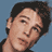 Static 48x48 pixel buddy icon showing a close-up of a person's face with dark hair against a solid blue background, rendered in low-resolution pixel art style.