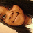 Pixelated close-up of a cartoon character's face with brown hair, dark eyes, and a neutral expression against a black background.