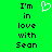 Green background with black pixelated text reading "I'm in love with Sean" and a white heart symbol above the text.