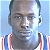 Pixelated celebrity mugshot-style image with green text overlay on a light blue background, featuring a person in a red and white striped jersey.