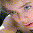A pixelated image split into four quadrants showing a person with light hair and a mermaid silhouette against a teal background.