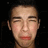 A pixelated face with closed eyes and red lips appears in three against a black background, the bottom-right shows only a gray rectangle