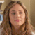 A static pixelated image of a person with light brown hair, closed eyes, and a neutral expression against a blurred background.