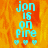 A pixelated image with cyan text reading 'jon is on fire' over an orange and yellow flame background, accompanied by three small heart symbols below the text.
