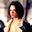 Static 48x48 pixel icon of a person with dark hair and light skin wearing a low-cut top, displayed against a blurred background.
