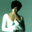 Pixelated static image of a person with dark hair wearing a white sleeveless top against a teal background, viewed from the side in profile.