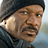 Pixelated promotional image for Mission Impossible 3 featuring a character in a dark beanie and gray jacket with text overlays on black and gray backgrounds.