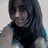 Pixelated static image of a person with long dark hair wearing a black top against a light background.