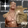 A muscular man with a bare torso stands against a dark background, holding a large golden trophy while white and yellow starburst effects animate around him