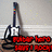 Pixelated static image shows a dark-colored guitar with white accents and red text on the body against a light gray background.