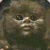 Pixelated close-up of a character's face with dark eyes, light skin tone, and visible mouth area against a muted background.