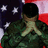 A person in camouflage uniform stands with hands clasped over chest against American flag background, visible from back.