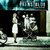 Pixelated static image shows a figure in white dress standing beside a large stylized 'F' and 'E' on dark background with teal accents.