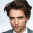 Pixelated close-up of a person with dark brown hair, light skin tone, and visible stubble wearing a blue garment against a white background.